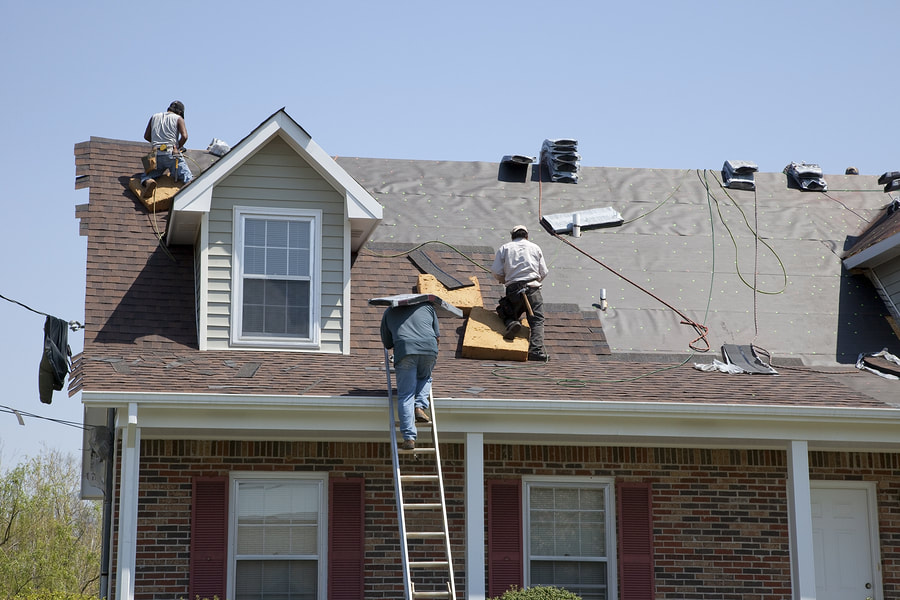 workers fixing the house roof